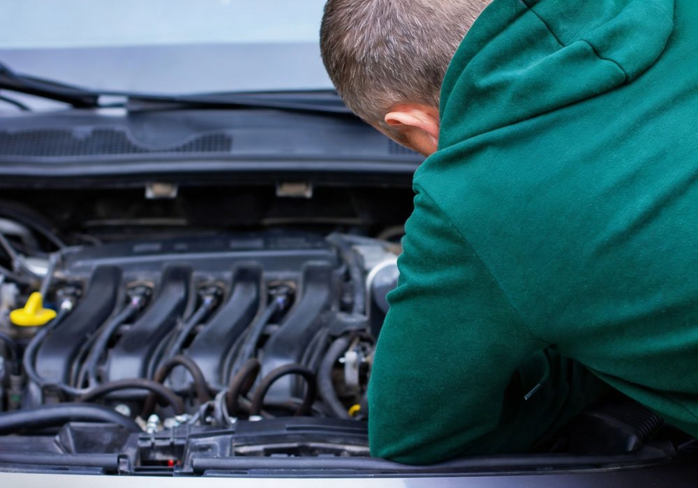 A mechanic servicing a car