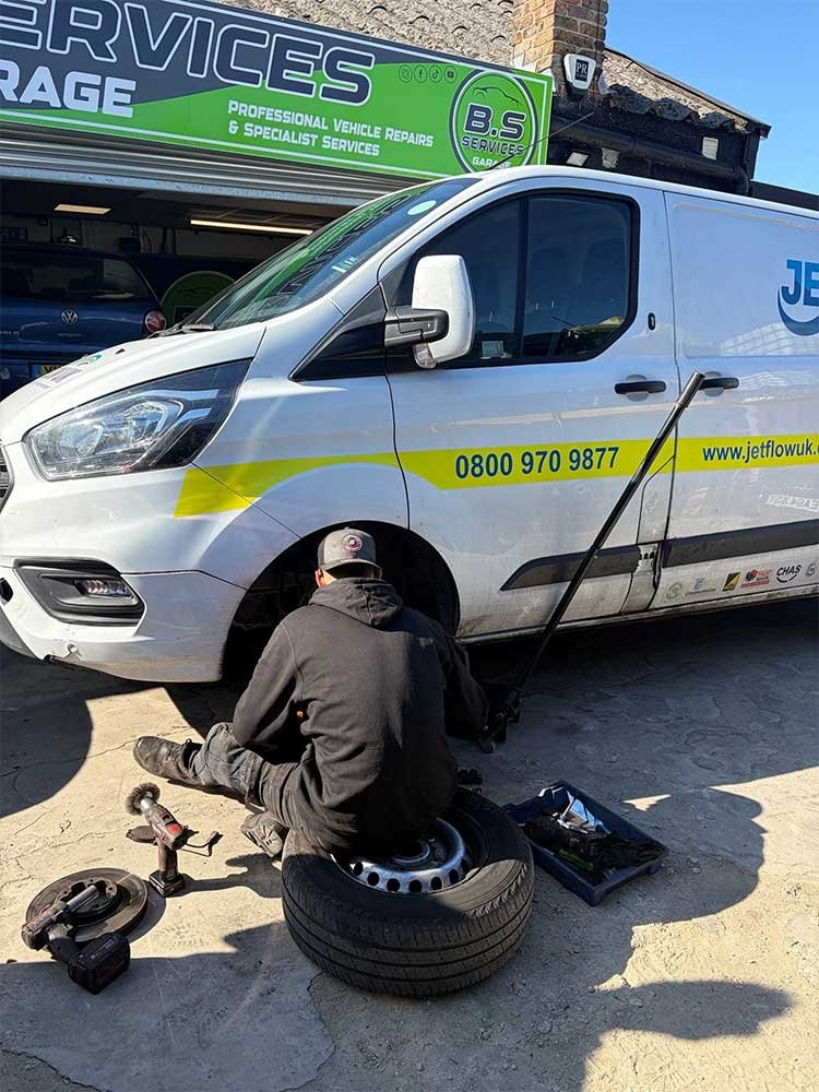 A BS Services mechanic working on a fleet vehicle